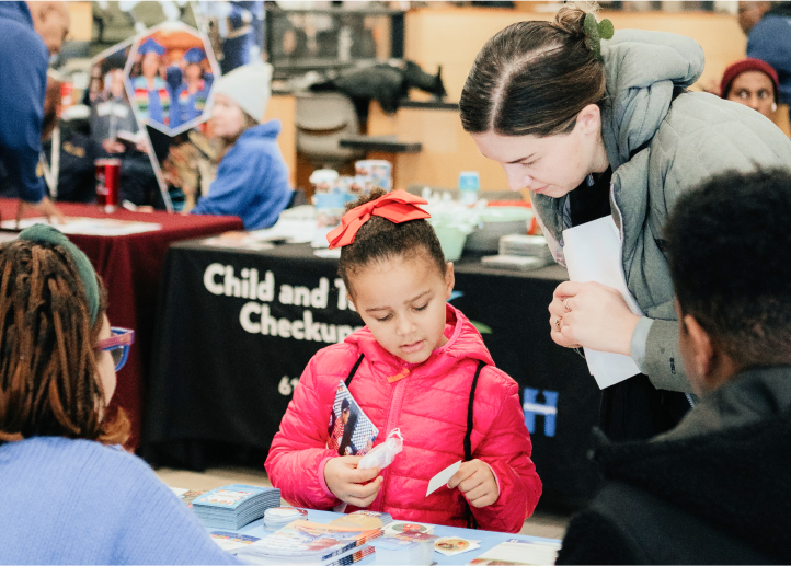 Child and parent at the Minneapolis School Finder Fair.