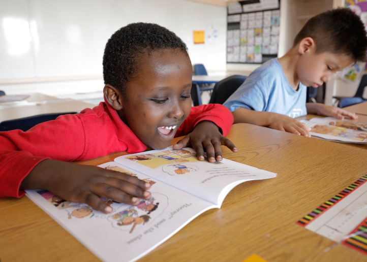 Student focusing on reading in a classroom.